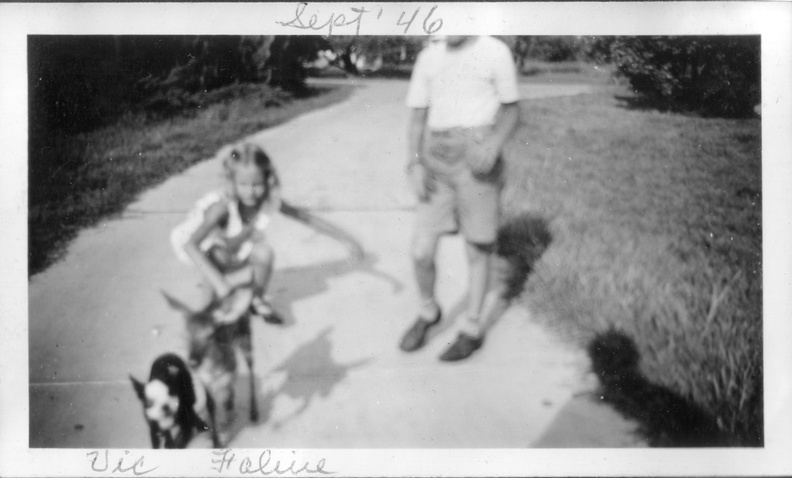 1946, Sept: Wallace watches Kathy play with Feline and Victory