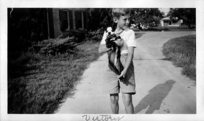 1946: Wally holding Victory in the driveway