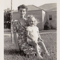 1941: Esther with Kathy in her lap in front of Sharyland home.