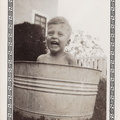 1938, June: Wally F cools off in a classic galvanized tub
