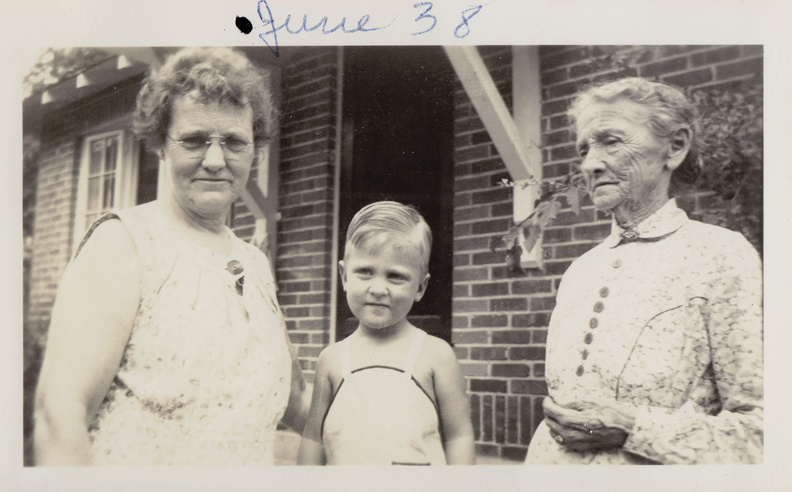 Wally Frank Bohannon flanked by his fraternal grandmother Ollie George Bohannon (left) and his great grandmother Bettie George. I think this is their home in Springfield, MO. It has a distinctive front porch that is seen in many photos. 38ollieBettieWally_jpeg.jpg