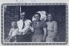1939, July: JM Bohannon holds his grandkids with Ollie and Bettie