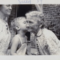 1939, July: Ollie looks on as Wally F kisses his ggma Bettie in Springfield, Mo
