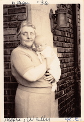 1936: Nerva holds 6 month old Wally at the entrance to Sunset Dr home.