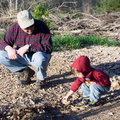 Dave and Wally select rocks to throw in the water