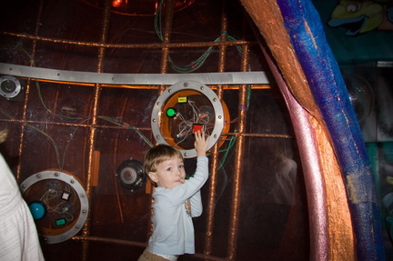 Wally pressing the buttons inside the space ship